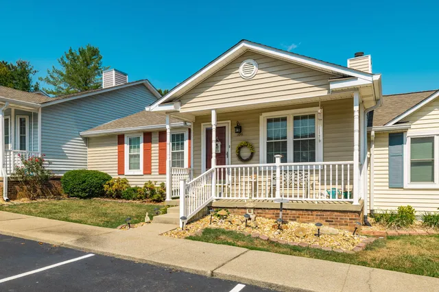 a view of a patio with table and chairs with wooden floor and fence