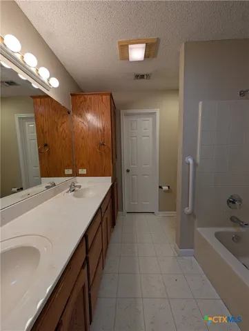 an empty room with a window and a ceiling fan