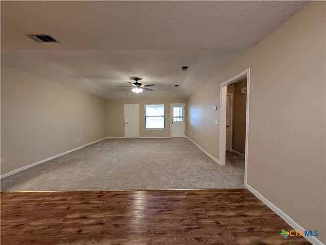 a view of livingroom and kitchen with wooden floor
