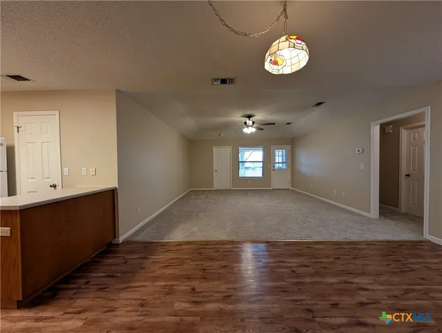 a view of a kitchen with a sink cabinets and wooden floor