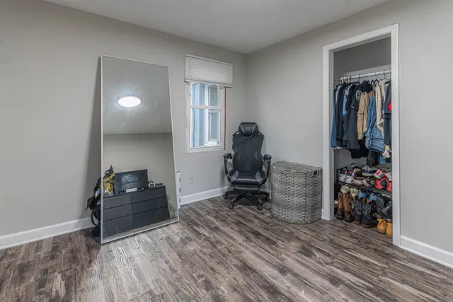 a view of a livingroom with workspace and a window