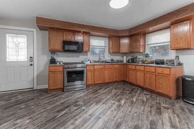 a kitchen with stainless steel appliances granite countertop a sink and cabinets