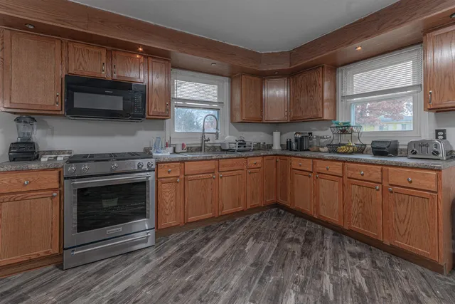a kitchen with a sink stove and microwave