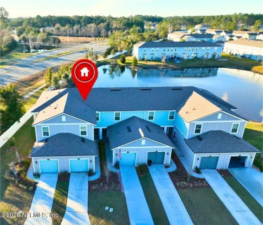 an aerial view of a house with a swimming pool yard and outdoor seating
