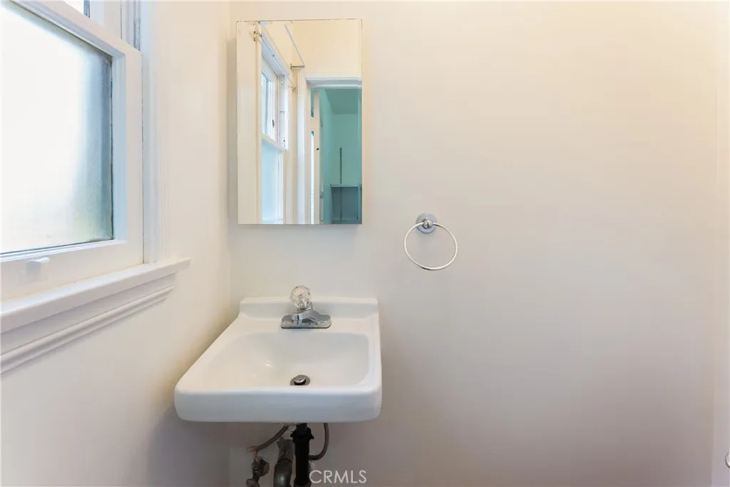 15207 Greenleaf Street Sherman Oaks, CA 91403 - Photo 22 of 32 a bathroom with a sink a mirror and a window