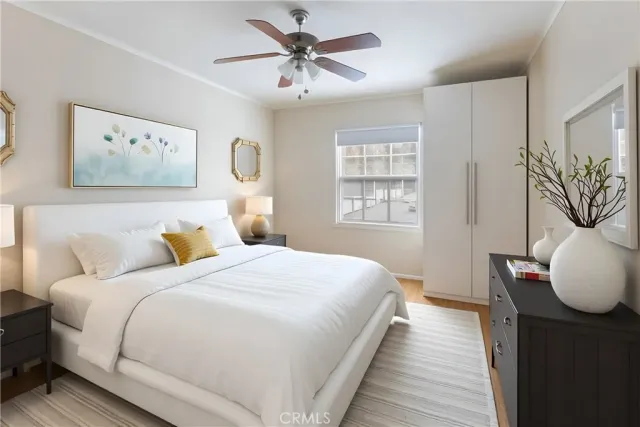 a bedroom with a large bed and a chandelier