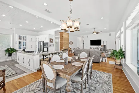 a very nice looking dining room with kitchen island stainless steel appliances a table and chair