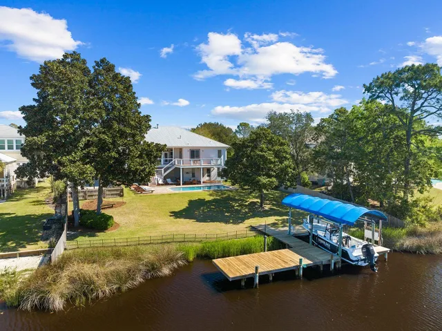 a view of a house with swimming pool and sitting area