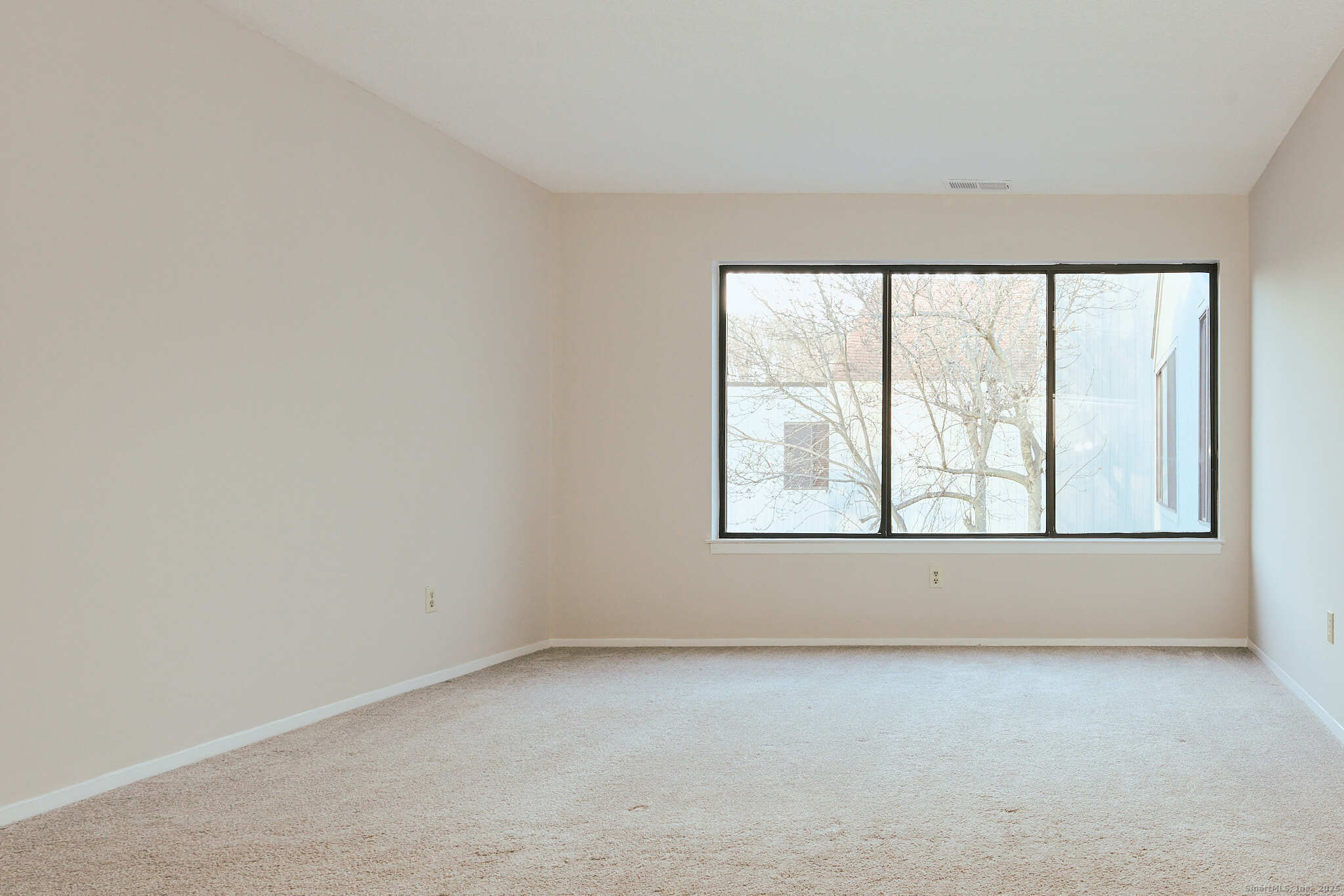 7 Elderberry Lane, Unit 7 Ridgefield, CT 06877 - Photo 5 of 26 an empty room with a window