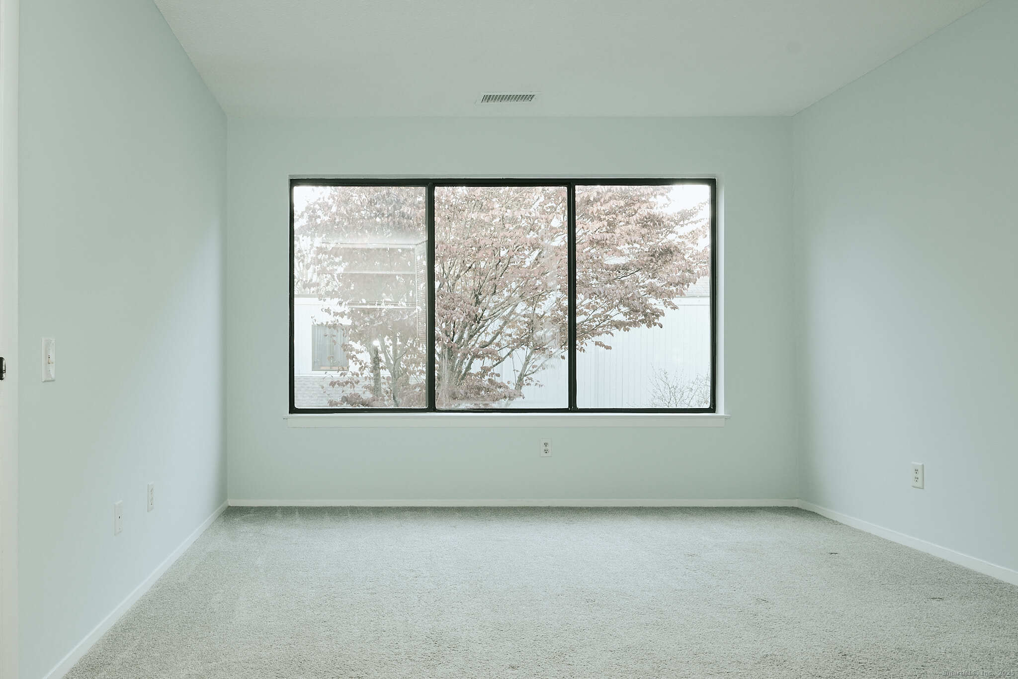 7 Elderberry Lane, Unit 7 Ridgefield, CT 06877 - Photo 9 of 26 an empty room with a window