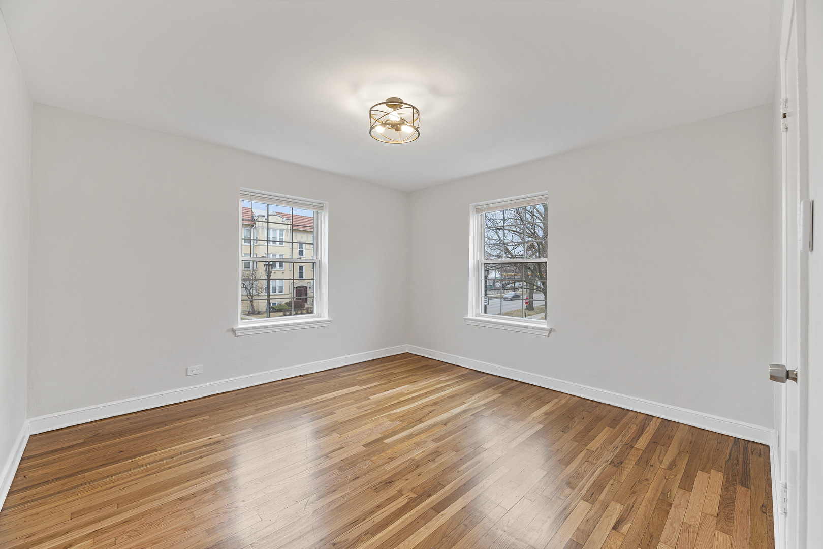 132 Ridge Avenue, Unit 2 Evanston, IL 60202 - Photo 9 of 14 a view of an empty room with a window and wooden floor