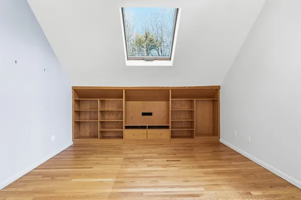 an empty room with closet and wooden floor
