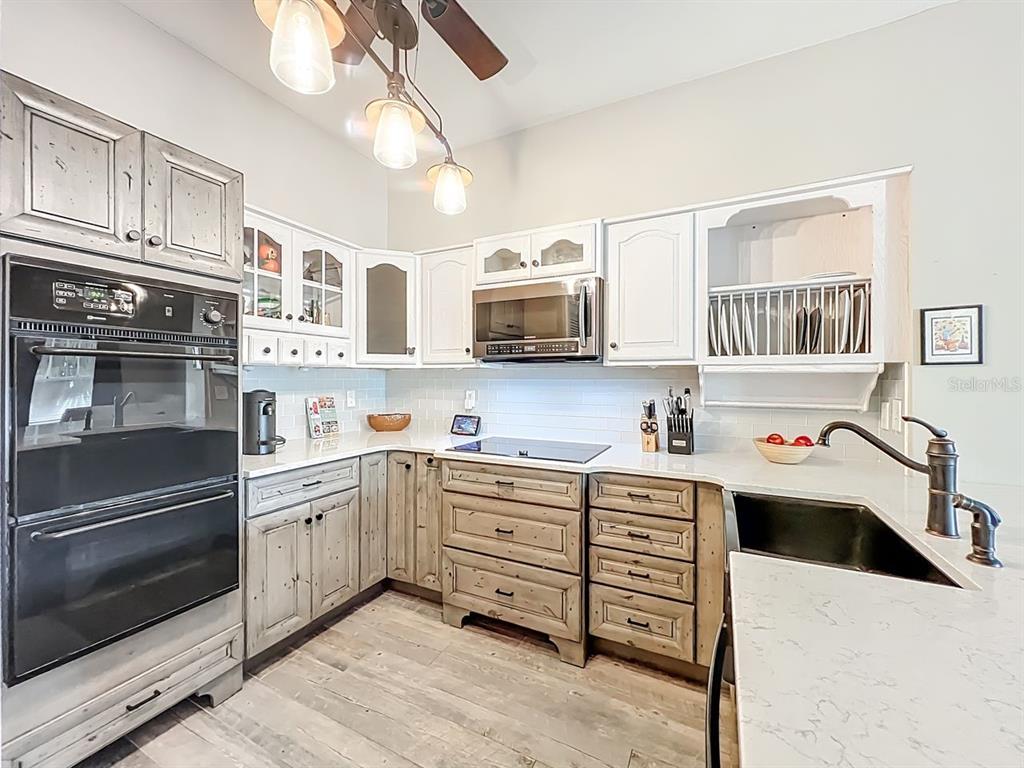 793 Celebration Avenue Celebration, FL 34747 - Photo 13 of 32 a kitchen with stainless steel appliances granite countertop a stove and cabinets