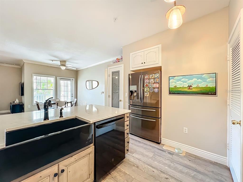 793 Celebration Avenue Celebration, FL 34747 - Photo 15 of 32 a kitchen with stainless steel appliances kitchen island granite countertop a refrigerator and a stove top oven