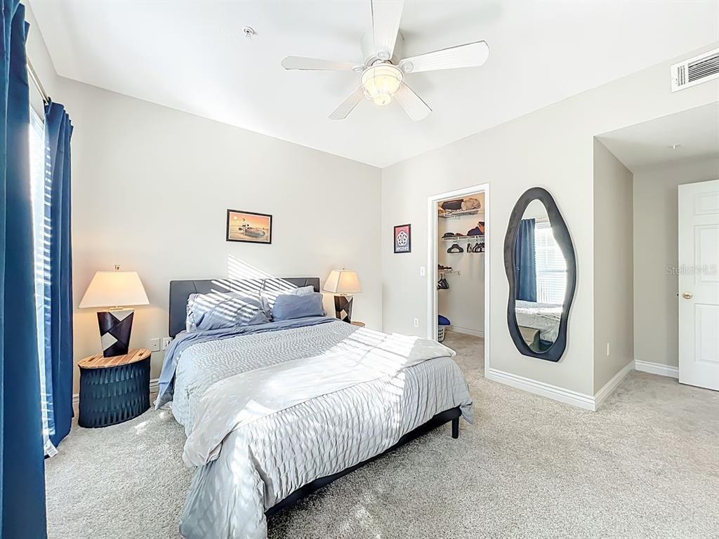 793 Celebration Avenue Celebration, FL 34747 - Photo 18 of 32 a bedroom with bed and a large mirror