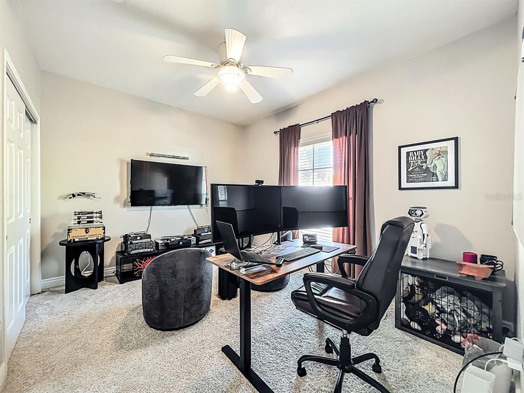 793 Celebration Avenue Celebration, FL 34747 - Photo 24 of 32 a view of a workspace with furniture and a flat screen tv