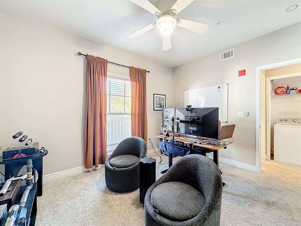 793 Celebration Avenue Celebration, FL 34747 - Photo 25 of 32 a living room with furniture a flat screen tv and a window