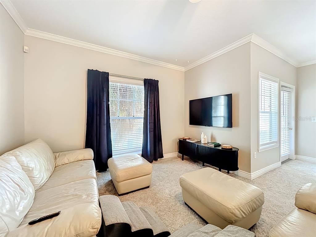 793 Celebration Avenue Celebration, FL 34747 - Photo 6 of 32 a living room with furniture and a flat screen tv
