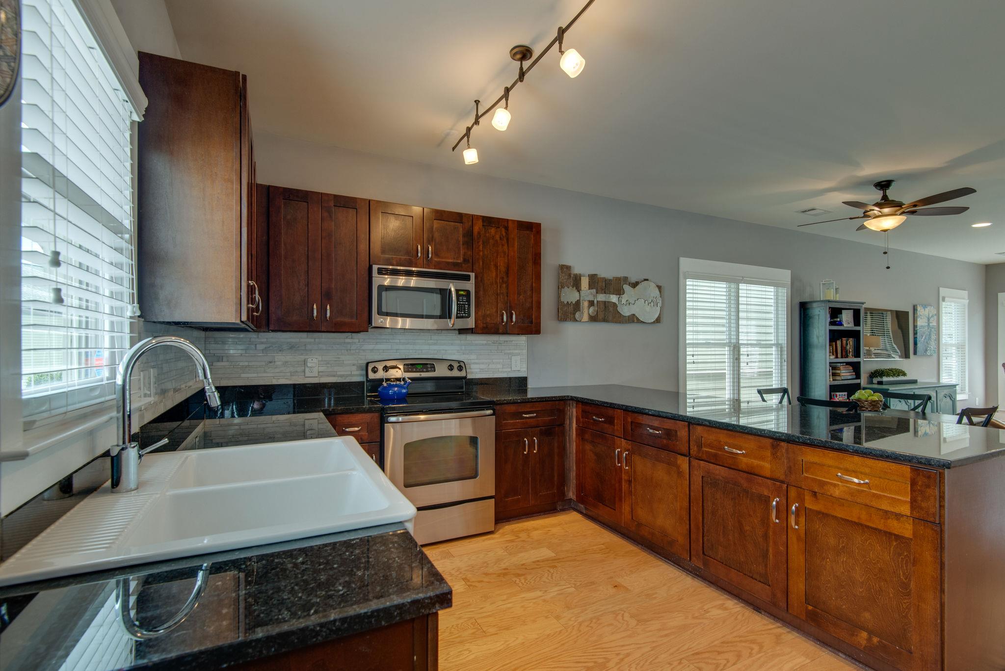 205 Copley Lane Nashville, TN 37204 - Photo 7 of 20 a kitchen with a sink a stove and cabinets