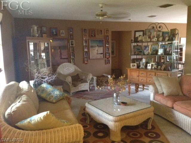 17409 Braddock Road Fort Myers, FL 33967 - Photo 2 of 18 a living room with furniture and chandelier