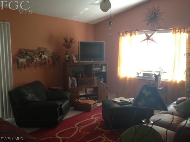 17409 Braddock Road Fort Myers, FL 33967 - Photo 3 of 18 a living room with furniture and a flat screen tv
