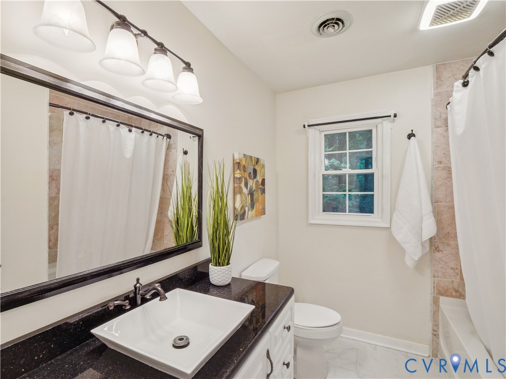 6530 Glebe Point Road Chesterfield, VA 23838 - Photo 26 of 41 a bathroom with a toilet sink and mirror