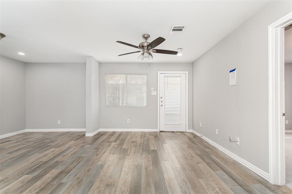 4931 Junius Street, Unit 4 Dallas, TX 75214 - Photo 12 of 31 wooden floor in an empty room with a window