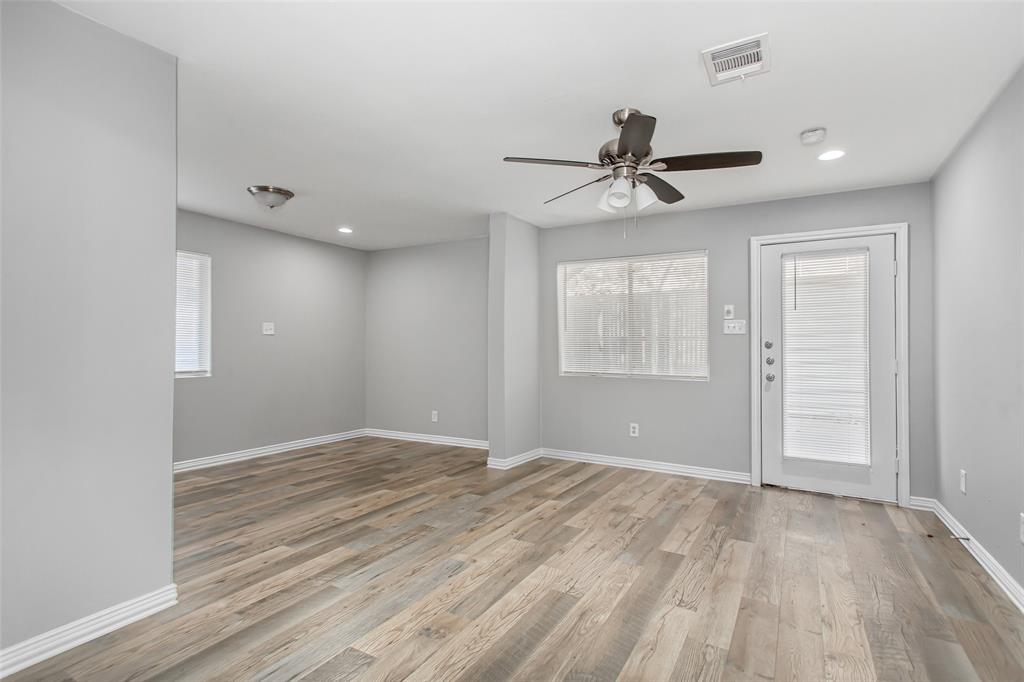 4931 Junius Street, Unit 4 Dallas, TX 75214 - Photo 13 of 31 wooden floor in an empty room with a window