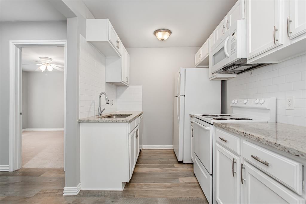 4931 Junius Street, Unit 4 Dallas, TX 75214 - Photo 15 of 31 a kitchen with stainless steel appliances granite countertop a stove and a sink