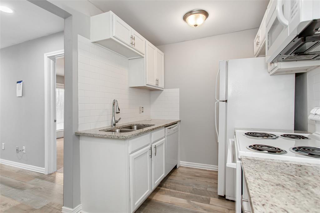 4931 Junius Street, Unit 4 Dallas, TX 75214 - Photo 16 of 31 a kitchen with stainless steel appliances granite countertop a stove and a refrigerator