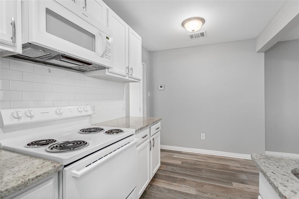 4931 Junius Street, Unit 4 Dallas, TX 75214 - Photo 17 of 31 a kitchen with a stove and a microwave