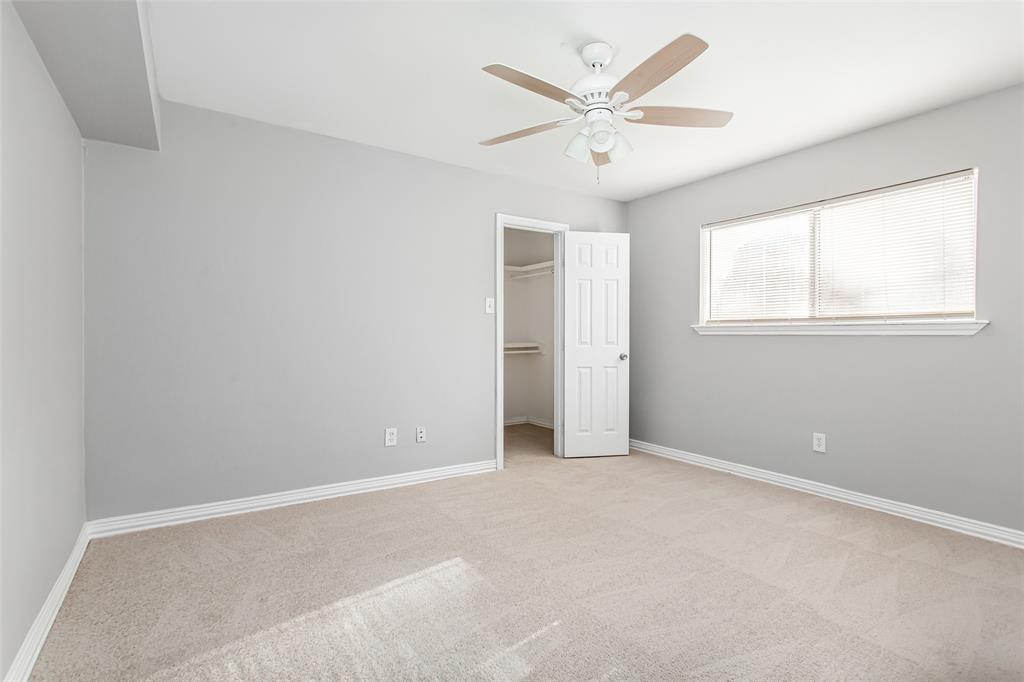 4931 Junius Street, Unit 4 Dallas, TX 75214 - Photo 19 of 31 an empty room with windows and fan