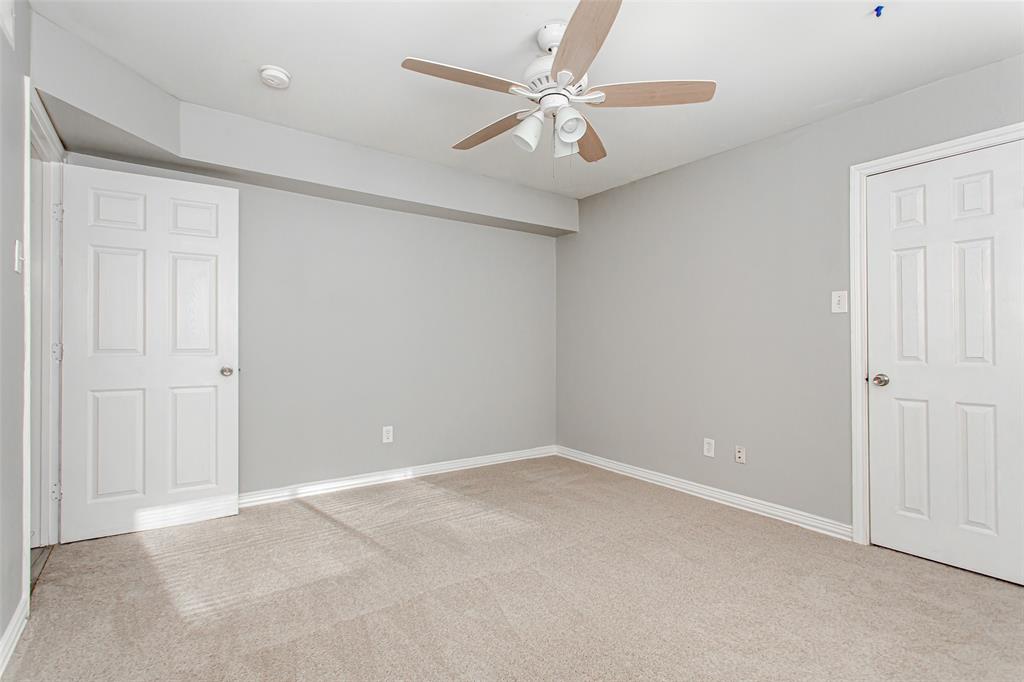 4931 Junius Street, Unit 4 Dallas, TX 75214 - Photo 20 of 31 an empty room with a ceiling fan and a window