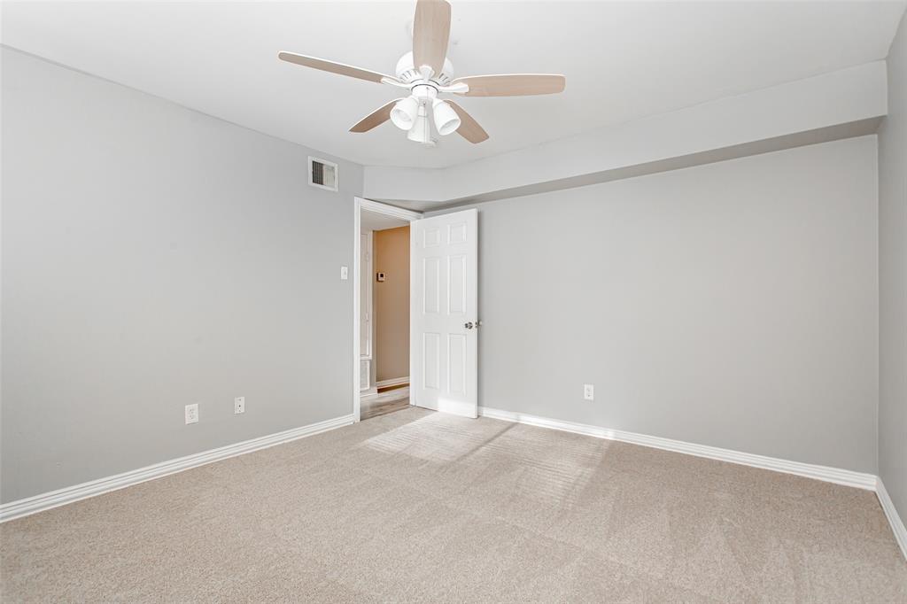 4931 Junius Street, Unit 4 Dallas, TX 75214 - Photo 21 of 31 an empty room with a ceiling fan and a window