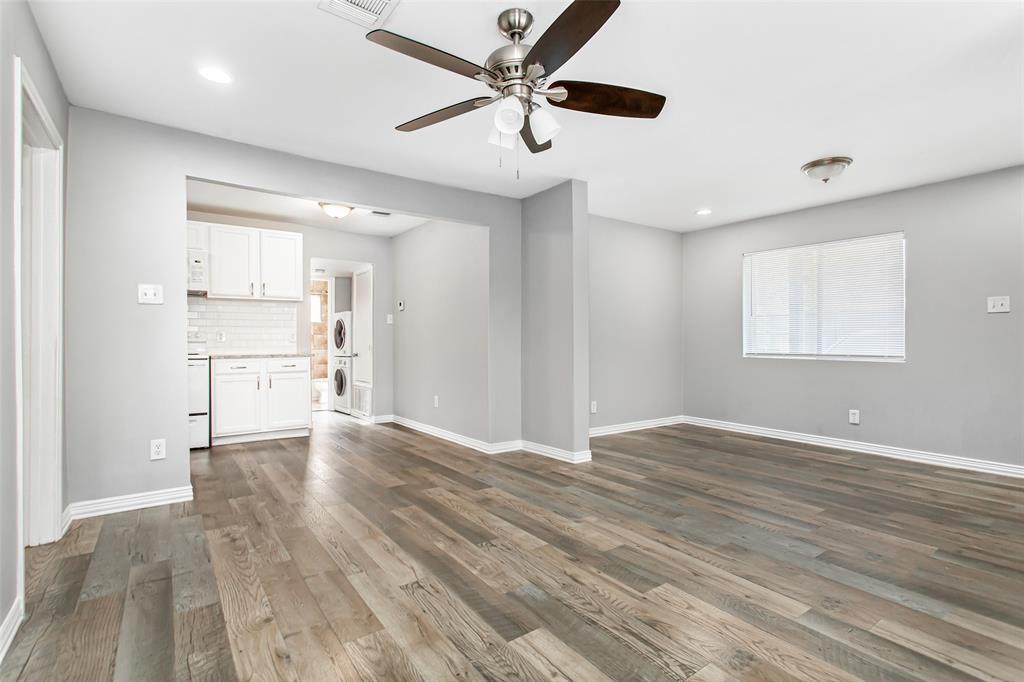 4931 Junius Street, Unit 4 Dallas, TX 75214 - Photo 7 of 31 a view of an empty room with window and wooden floor