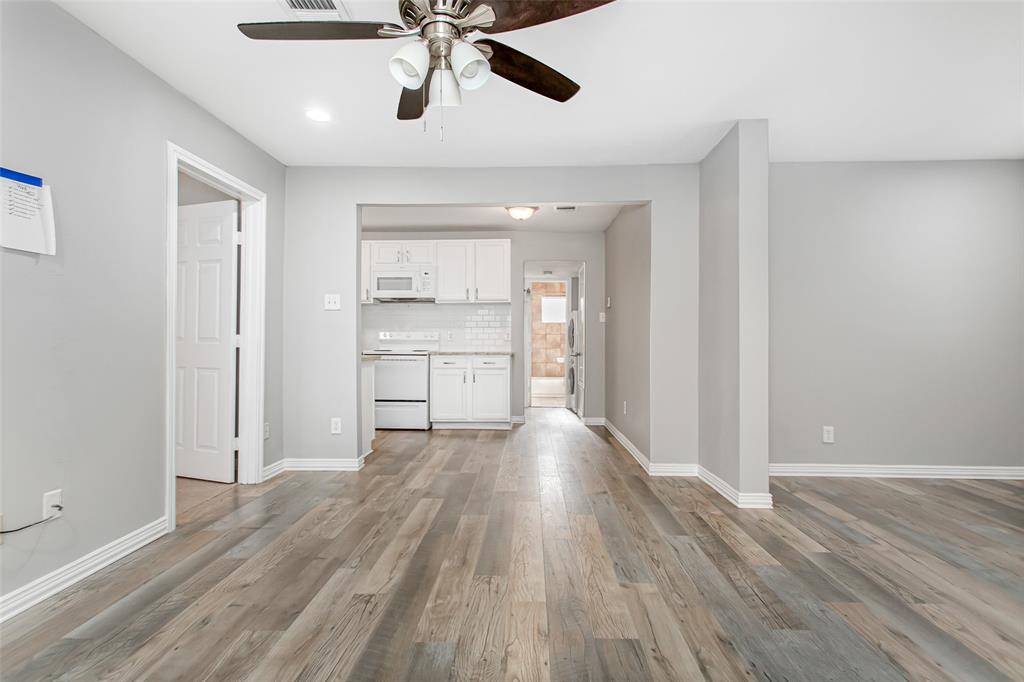 4931 Junius Street, Unit 4 Dallas, TX 75214 - Photo 8 of 31 a view of a kitchen with wooden floor a sink and a window