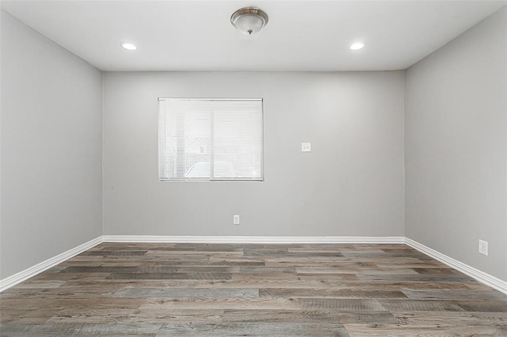 4931 Junius Street, Unit 4 Dallas, TX 75214 - Photo 9 of 31 a view of a room with wooden floor and fan