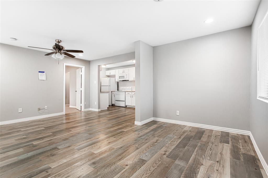 4931 Junius Street, Unit 4 Dallas, TX 75214 - Photo 10 of 31 wooden floor in an empty room with a window
