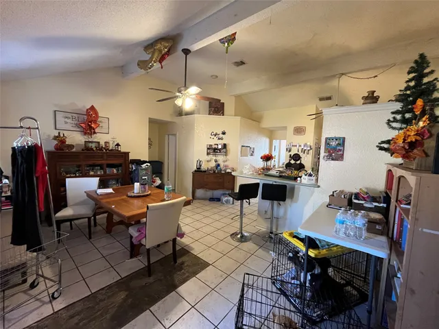 a living room with lots of furniture and clutter