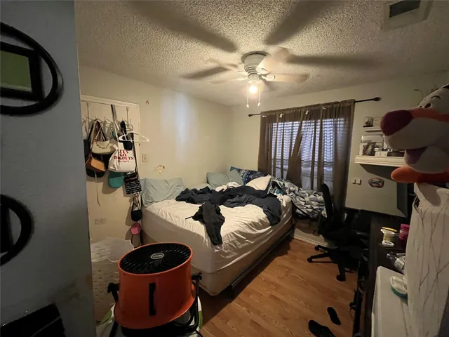 a bed room with a bed a mirror and dresser