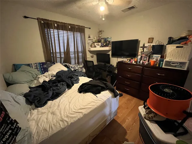 a bed room with a bed and a television