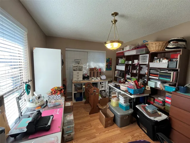 a living room filled with lots of furniture and a chandelier