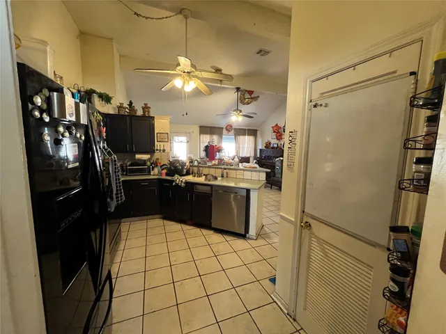 a kitchen with a refrigerator a sink and dishwasher