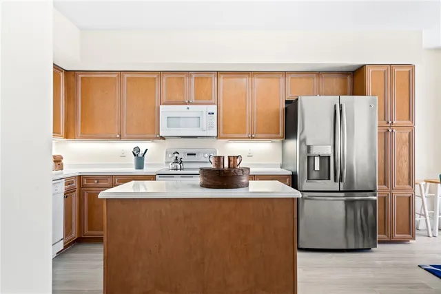 a kitchen with stainless steel appliances granite countertop a refrigerator sink and cabinets