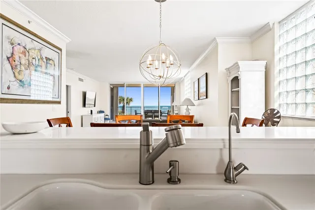 a very nice looking open dining room with kitchen view