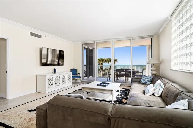 a living room with furniture large window and a flat screen tv