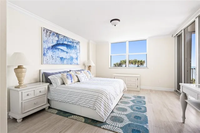 a bedroom with a bed and a painting on the wall