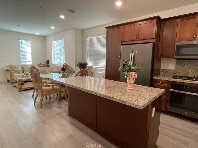 a kitchen with a table chairs and a refrigerator
