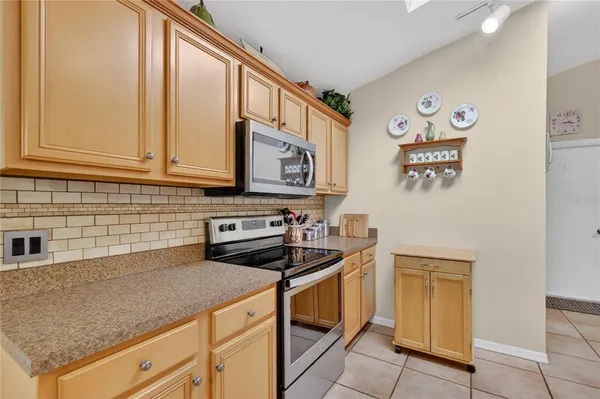 a kitchen with stainless steel appliances granite countertop a sink stove and cabinets