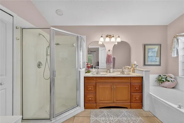 a bathroom with a granite countertop sink a mirror and shower